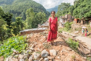 Dipkumari Shrestha standing in the rubble of her former home in Hattigauda